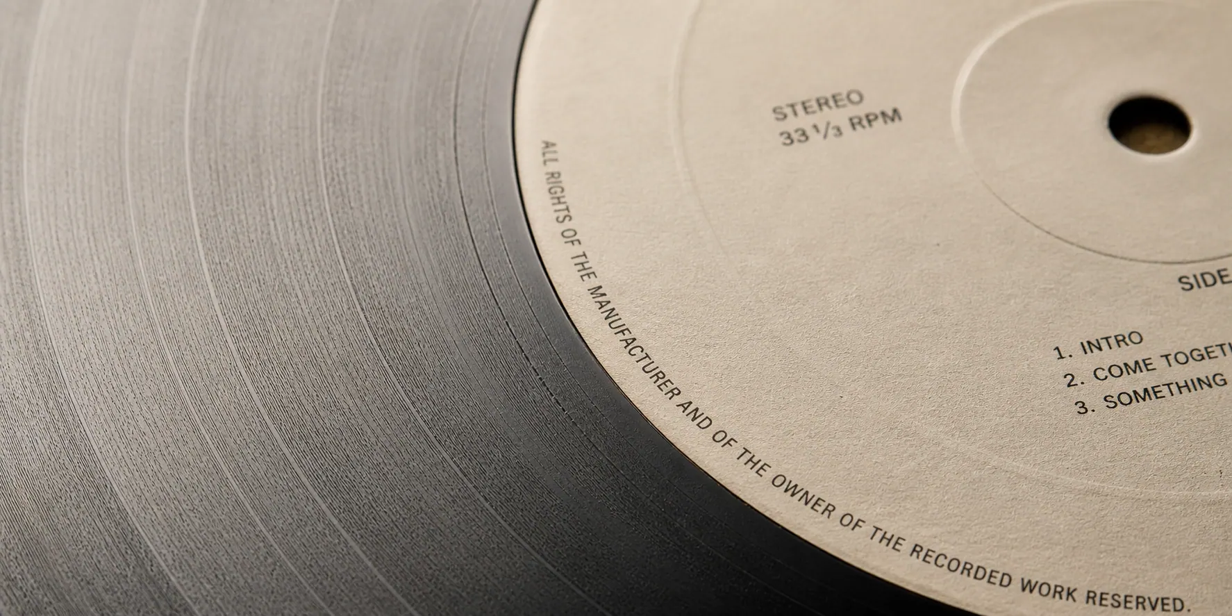 Close-up of a vinyl record label — STEREO 33⅓ RPM, crisp detail on bone background